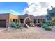 Charming home exterior with desert landscaping and a decorative gated entrance at 8406 E Calle Buena Vis, Scottsdale, AZ 85255