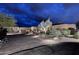 Desert home exterior at dusk with unique desert landscaping and illuminated pathway at 8406 E Calle Buena Vis, Scottsdale, AZ 85255