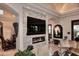 Comfortable living room features a stone fireplace, a large TV, and lots of natural light at 8406 E Calle Buena Vis, Scottsdale, AZ 85255