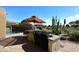 Outdoor kitchen featuring a grill, bar seating, and beautiful landscaping with pool view at 8406 E Calle Buena Vis, Scottsdale, AZ 85255