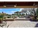 Expansive stone patio features a cozy seating area with a fire pit and golf course views at 8406 E Calle Buena Vis, Scottsdale, AZ 85255