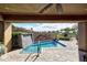 Covered patio area overlooking the pool with mature plants for shade and privacy at 8406 E Calle Buena Vis, Scottsdale, AZ 85255