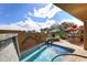 Private pool area with water feature, mature landscaping, outdoor bar, and umbrella at 8406 E Calle Buena Vis, Scottsdale, AZ 85255