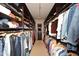 Spacious walk-in closet with custom shelves and clothing racks for optimal storage and organization at 8406 E Calle Buena Vis, Scottsdale, AZ 85255
