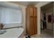 Bright bathroom featuring a jacuzzi tub, storage cabinet, and an open entrance to a walk-in closet at 890 E Tee St, San Tan Valley, AZ 85140