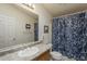 Well-lit bathroom features a large mirror and a blue patterned shower curtain at 890 E Tee St, San Tan Valley, AZ 85140