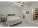 Cozy bedroom boasts a soft color palette with seamless access to both the ensuite bathroom and walk-in closet at 890 E Tee St, San Tan Valley, AZ 85140