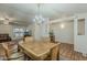 Bright dining area with laminate floors, classic lighting, and a seamless transition to the living area at 890 E Tee St, San Tan Valley, AZ 85140