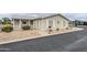 Inviting single-story home with a well-maintained yard and a quaint front porch at 890 E Tee St, San Tan Valley, AZ 85140