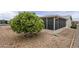 Outdoor space with decorative gravel and lush tree with a screened in porch at 890 E Tee St, San Tan Valley, AZ 85140