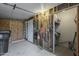 Unfinished garage space with storage for tools and supplies, with a door to the outside at 890 E Tee St, San Tan Valley, AZ 85140