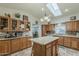 Bright kitchen with an island, stainless steel sink, and tile backsplash at 890 E Tee St, San Tan Valley, AZ 85140
