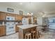 Well-lit kitchen featuring an island with barstool seating and white appliances at 890 E Tee St, San Tan Valley, AZ 85140