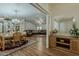 Open-concept living area features a dining set, wood floors, and a comfortable lounge area at 890 E Tee St, San Tan Valley, AZ 85140
