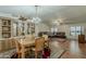 Spacious living area with wood floors, dining set, built-in cabinet, and comfortable seating at 890 E Tee St, San Tan Valley, AZ 85140