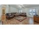 Inviting living room features a plush leather sectional, ceiling fan, and neutral paint at 890 E Tee St, San Tan Valley, AZ 85140