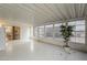 Bright sunroom with white floors, walls, and ceiling, featuring large windows and a view to the outside at 890 E Tee St, San Tan Valley, AZ 85140