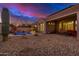 Expansive backyard featuring a pool, covered patio, and desert landscaping, perfect for outdoor living and entertaining at 9604 S 183Rd Dr, Goodyear, AZ 85338