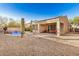 Desert landscaping and in-ground pool with covered patio seating, exterior view from the side yard at 9604 S 183Rd Dr, Goodyear, AZ 85338