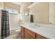 Tiled bathroom with a shower-tub combo, bright lighting, and a single vanity at 9604 S 183Rd Dr, Goodyear, AZ 85338