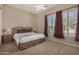 Cozy bedroom with plush carpet, ample natural light, and simple, clean decor at 9604 S 183Rd Dr, Goodyear, AZ 85338