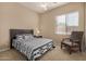 Bedroom with a reading chair, natural light, and a ceiling fan at 9604 S 183Rd Dr, Goodyear, AZ 85338