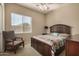 Bedroom with a reading chair, natural light, and a well-decorated bed at 9604 S 183Rd Dr, Goodyear, AZ 85338