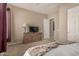 Bedroom featuring a ceiling fan, natural light, and an ensuite bathroom at 9604 S 183Rd Dr, Goodyear, AZ 85338