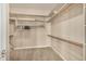 Walk-in closet with neutral carpet, a single hanging rod, and shelves for storage at 9604 S 183Rd Dr, Goodyear, AZ 85338