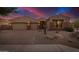 Attractive desert home featuring a three-car garage and manicured gravel landscaping at 9604 S 183Rd Dr, Goodyear, AZ 85338