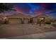 Attractive desert home featuring a three-car garage, and manicured desert landscaping at 9604 S 183Rd Dr, Goodyear, AZ 85338