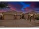 Attractive desert home featuring a three-car garage, and desert landscaping at 9604 S 183Rd Dr, Goodyear, AZ 85338