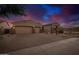 Charming desert home featuring a three-car garage and gravel landscaping at 9604 S 183Rd Dr, Goodyear, AZ 85338