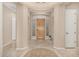 Inviting foyer featuring tile flooring, neutral walls, and an attractive front door at 9604 S 183Rd Dr, Goodyear, AZ 85338