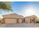 Single-story home with a three-car garage, desert landscaping, and a tile roof at 9604 S 183Rd Dr, Goodyear, AZ 85338