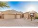 Charming single-story home with a three-car garage, desert landscaping, and tile roof at 9604 S 183Rd Dr, Goodyear, AZ 85338