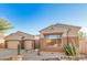Attractive single-story home featuring a three car garage and desert landscaping with native plants at 9604 S 183Rd Dr, Goodyear, AZ 85338