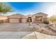 Charming single-story home with a three-car garage and desert landscaping at 9604 S 183Rd Dr, Goodyear, AZ 85338