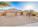 Lovely single-story home with a three-car garage, desert landscaping, and tile roof at 9604 S 183Rd Dr, Goodyear, AZ 85338