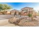 Beautiful single-story home with desert landscaping, gravel, cacti, and a three car garage at 9604 S 183Rd Dr, Goodyear, AZ 85338