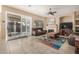 Bright living room featuring sliding glass doors, fireplace, and tile floors at 9604 S 183Rd Dr, Goodyear, AZ 85338