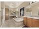 Luxurious main bathroom showcasing a soaking tub, dual sinks, and vanity at 9604 S 183Rd Dr, Goodyear, AZ 85338