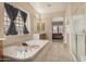 Large main bathroom featuring a soaking tub, separate shower, and tiled floors at 9604 S 183Rd Dr, Goodyear, AZ 85338