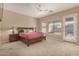 Comfortable main bedroom with a ceiling fan, neutral colors, and carpeted floors at 9604 S 183Rd Dr, Goodyear, AZ 85338
