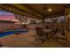 Covered patio featuring a dining table, ceiling fan, and outdoor kitchen, perfect for entertaining and enjoying the desert lifestyle at 9604 S 183Rd Dr, Goodyear, AZ 85338