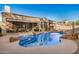 Backyard view of the private in-ground pool with baja step, desert landscaping, and covered patio seating area at 9604 S 183Rd Dr, Goodyear, AZ 85338