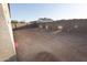 The backyard is a blank canvas with dirt and concrete walls, offering a private outdoor area at 10005 W Mission Dr, Arizona City, AZ 85123