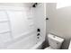 This bathroom features a toilet, and a shower-tub combination with built-in shelving at 10005 W Mission Dr, Arizona City, AZ 85123