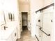 Bright bathroom with a modern vanity, glass-enclosed shower, and walk-in closet at 10005 W Mission Dr, Arizona City, AZ 85123