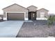 Charming single-story home with desert landscaping and a two-car garage at 10005 W Mission Dr, Arizona City, AZ 85123